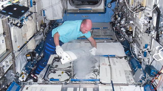 NASA image: Kuipers prepares to insert biological samples in the MELFI