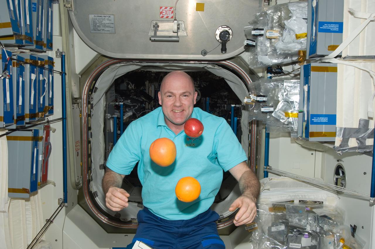 ISS030-E-117506 (3 Feb. 2012) --- European Space Agency astronaut Andre Kuipers, Expedition 30 flight engineer, is pictured near fruit floating freely in the Unity node of the International Space Station.