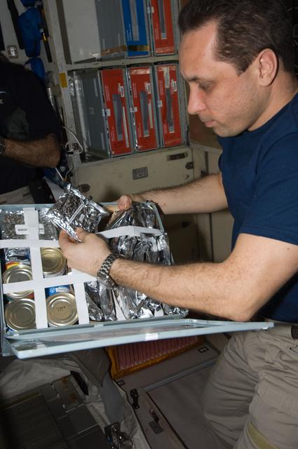 NASA image: Shkaplerov makes a selection from food container