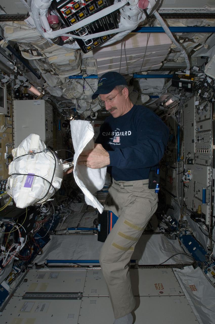 ISS030-E-122089 (6 March 2012) --- NASA astronaut Dan Burbank, Expedition 30 commander, opens a Contingency Water Container-Iodinated (CWC-I) bag in the Kibo laboratory of the International Space Station.