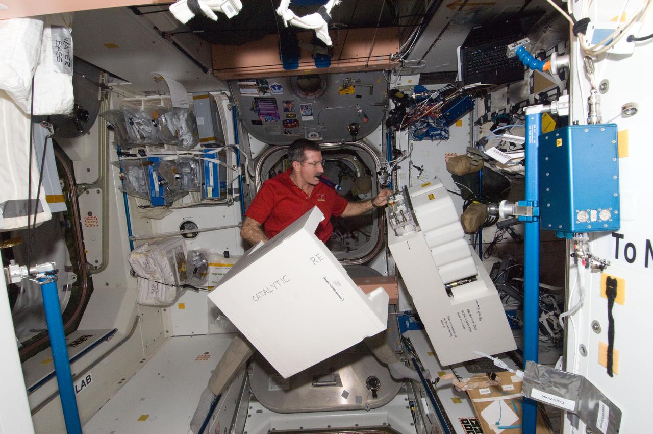 ISS030-E-128841 (8 March 2012) --- NASA astronaut Dan Burbank, Expedition 30 commander, works with Catalytic Reactor hardware in the Unity node of the International Space Station.