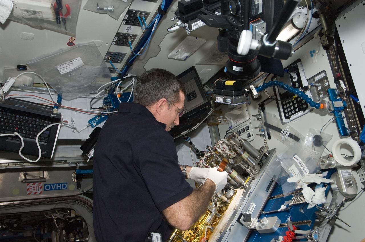 ISS030-E-128878 (9 March 2012) --- At a workstation in the International Space Station?s Harmony node, NASA astronaut Dan Burbank, Expedition 30 commander, replaces a Catalytic Reactor in the Water Recovery System.