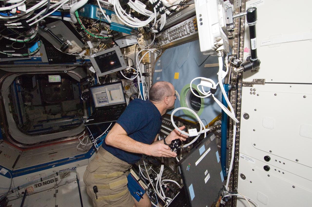 ISS030-E-128918 (9 March 2012) --- NASA astronaut Don Pettit, Expedition 30 flight engineer, works with the Structure and Liftoff In Combustion Experiment (SLICE) at the Microgravity Sciences Glovebox (MSG) in the Destiny laboratory of the International Space Station. Pettit conducted three sets of  flame tests, followed by a fan calibration. This test will lead to increased efficiency and reduced pollutant emission for practical combustion devices.