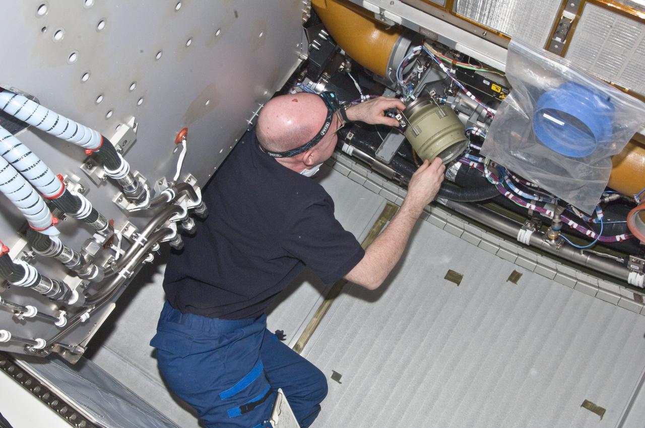 ISS030-E-129474 (22 Feb. 2012) --- European Space Agency astronaut Andre Kuipers, Expedition 30 flight engineer, performs the scheduled inspection and extensive cleanup of ventilation systems and ventilation ducts in the Columbus laboratory of the International Space Station.