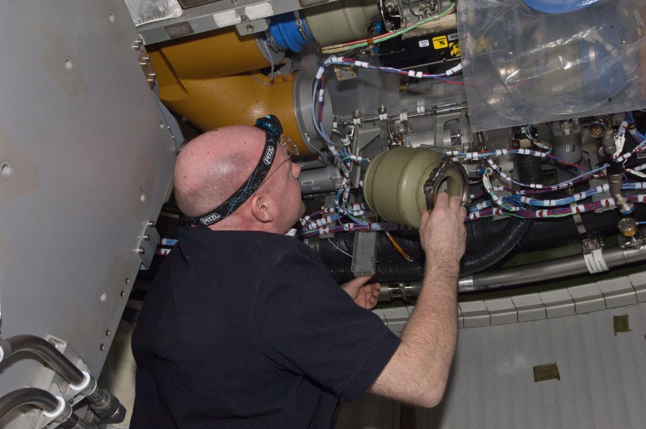 ISS030-E-129476 (22 Feb. 2012) --- European Space Agency astronaut Andre Kuipers, Expedition 30 flight engineer, performs the scheduled inspection and extensive cleanup of ventilation systems and ventilation ducts in the Columbus laboratory of the International Space Station.