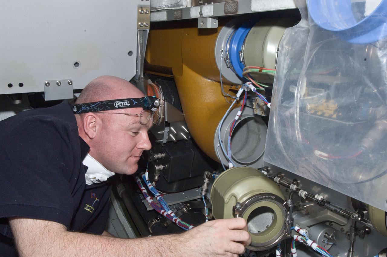 ISS030-E-129477 (22 Feb. 2012) --- European Space Agency astronaut Andre Kuipers, Expedition 30 flight engineer, performs the scheduled inspection and extensive cleanup of ventilation systems and ventilation ducts in the Columbus laboratory of the International Space Station.