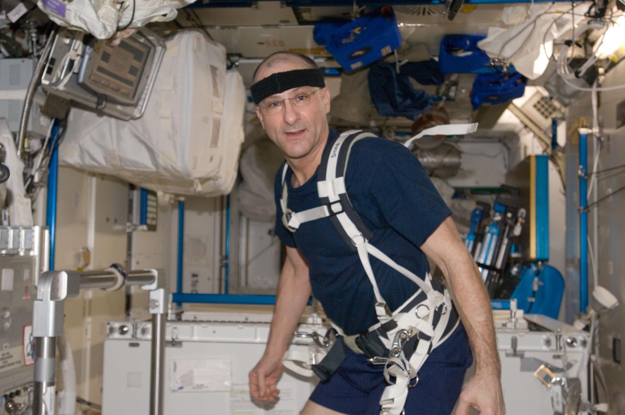 ISS030-E-132525 (6 March 2012) --- NASA astronaut Don Pettit, Expedition 30 flight engineer, equipped with a bungee harness, prepares to exercise on the Combined Operational Load Bearing External Resistance Treadmill (COLBERT) in the Tranquility node of the International Space Station.