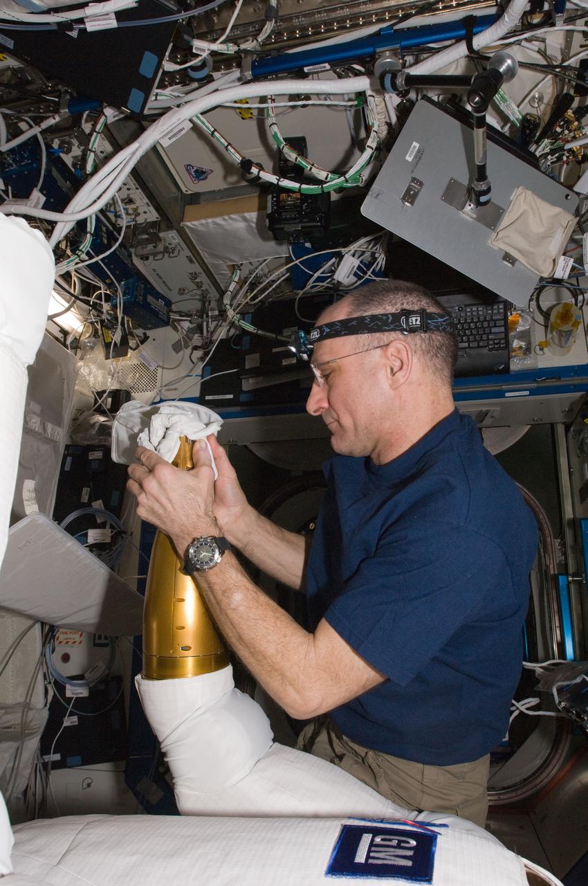 ISS030-E-135119 (13 March 2012) --- In the International Space Station?s Destiny laboratory, NASA astronaut Don Pettit, Expedition 30 flight engineer, replaces the cover on an arm of Robonaut 2 after an upgrade to its systems. A heat sink was installed into both of the robot?s forearms to allow it to better dissipate heat and run for longer periods of time.