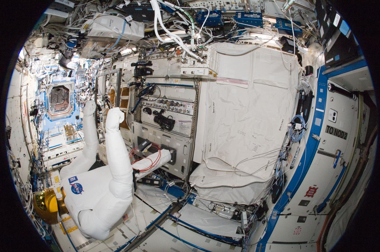 ISS030-E-135148 (13 March 2012) --- A fisheye lens attached to an electronic still camera was used to capture this image of Robonaut 2 humanoid robot during another system checkout in the Destiny laboratory of the International Space Station. Teams on the ground commanded Robonaut through a series of dexterity tests as it spelled out ?Hello world? in sign language.