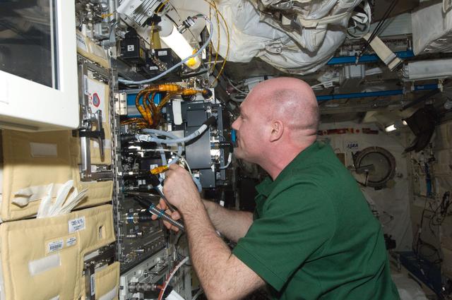 NASA image: Kuipers works to remove the Marangoni Suface Fluid Physics Experiment