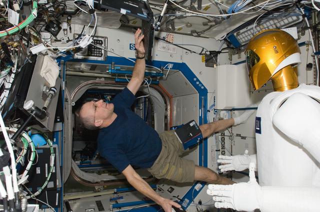 NASA image: Pettit enters data in a laptop computer