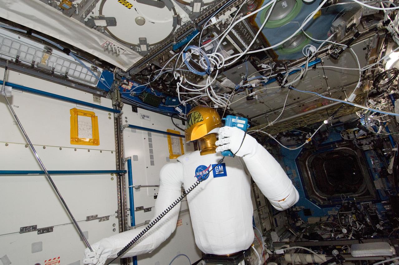 ISS030-E-148257 (14 March 2012) --- Controlled by teams on the ground, Robonaut 2 humanoid robot holds an instrument to measure air velocity during another system check out in the Destiny laboratory of the International Space Station.