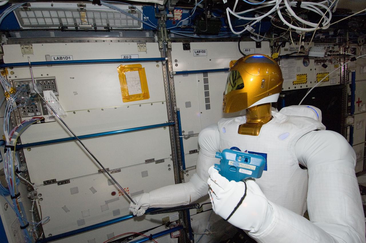 ISS030-E-148260 (14 March 2012) --- Controlled by teams on the ground, Robonaut 2 humanoid robot holds an instrument to measure air velocity during another system check out in the Destiny laboratory of the International Space Station.