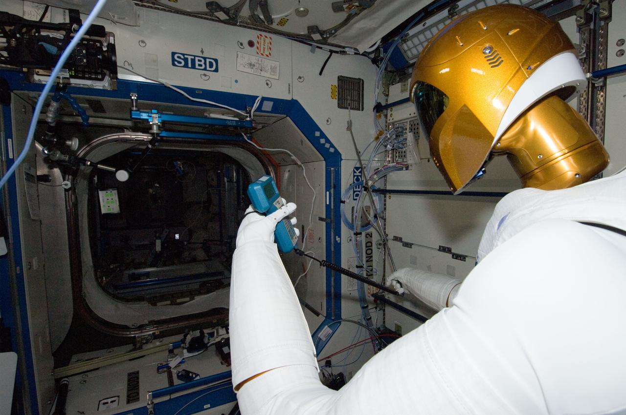 ISS030-E-148268 (14 March 2012) --- Controlled by teams on the ground, Robonaut 2 humanoid robot holds an instrument to measure air velocity during another system check out in the Destiny laboratory of the International Space Station.