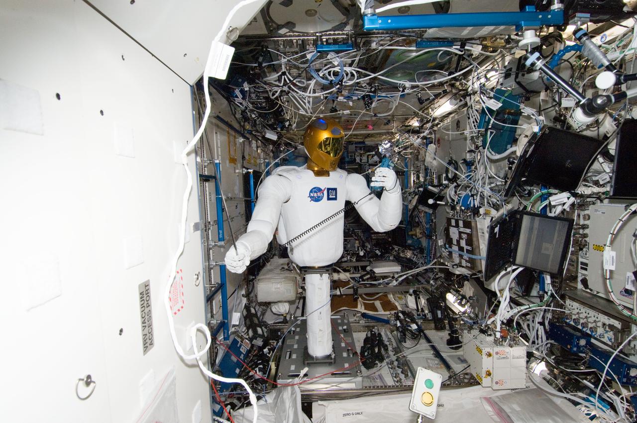 ISS030-E-148273 (14 March 2012) --- Controlled by teams on the ground, Robonaut 2 humanoid robot holds an instrument to measure air velocity during another system check out in the Destiny laboratory of the International Space Station.