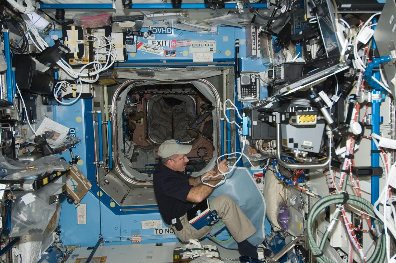 ISS030-E-155912 (16 Jan. 2012) --- NASA astronaut Dan Burbank, Expedition 30 commander, performs in-flight maintenance on the front stray light cover for the Microgravity Science Glovebox (MSG) in the Destiny laboratory of the International Space Station.