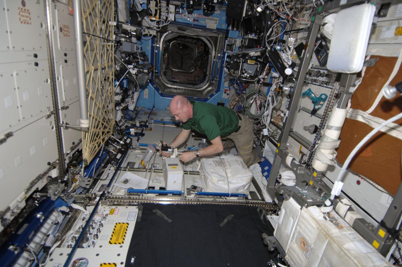 ISS030-E-156455 (26 Jan. 2012) --- European Space Agency astronaut Andre Kuipers, Expedition 30 flight engineer, sets up the Compound Specific Analyzer - Combustion Products (CSA-CP) in the Destiny laboratory of the International Space Station. The purpose of the analyzer is to measure the concentrations of carbon monoxide, hydrogen cyanide, hydrogen chloride and oxygen.