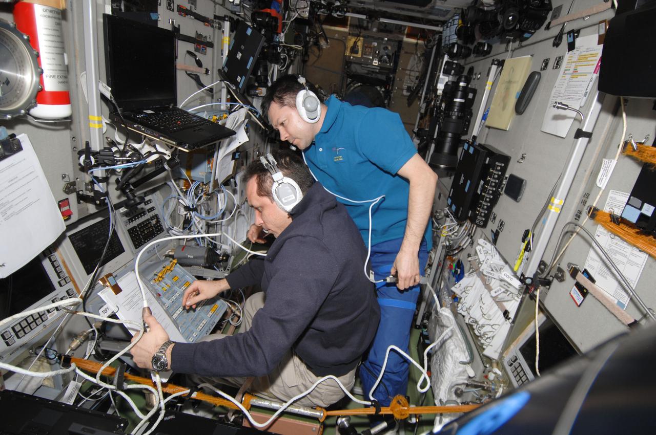 ISS030-E-156562 (27 Jan. 2012) --- Russian cosmonauts Anton Shkaplerov (left) and Oleg Kononenko, both Expedition 30 flight engineers, monitor data at the manual TORU docking system controls in the Zvezda Service Module of the International Space Station during approach and docking operations of the unpiloted ISS Progress 46 resupply vehicle. Progress 46 docked automatically to the Pirs Docking Compartment via the Kurs automated rendezvous system at 7:00 p.m. (EST) on Jan. 27, 2012.