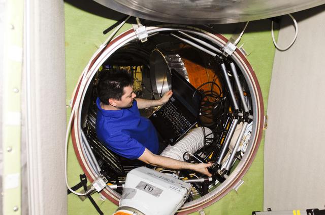 NASA image: Kononenko uses laptop computer in the SM Transfer Compartment