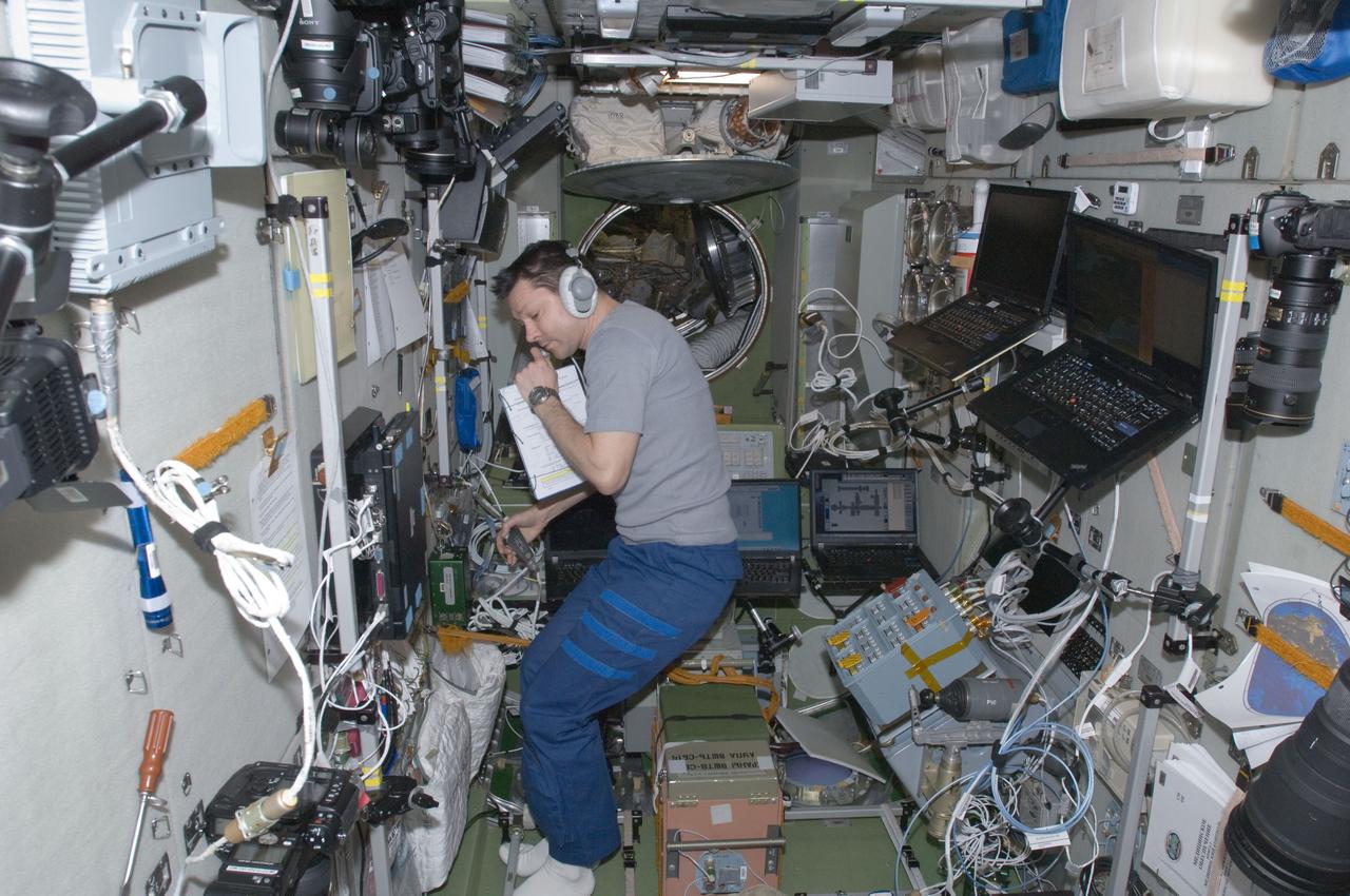 ISS030-E-171108 (24 March 2012) --- Russian cosmonaut Oleg Kononenko, Expedition 30 flight engineer, wearing a communication headset, is pictured in the Zvezda Service Module of the International Space Station as crew members prepare for their move to the appropriate Soyuz vehicles, due to the possibility that space debris could pass close to the station. Burbank, Shkaplerov and Ivanishin sheltered in the Soyuz TMA-22 spacecraft attached to the Poisk Mini-Research Module 2 (MRM2) while Kononenko, Kuipers and Pettit took to the Soyuz TMA-03M docked to the Rassvet Mini-Research Module 1 (MRM-1).