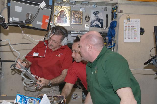 NASA image: Burbank, Shkaplerov, and Kuipers review crew procedures