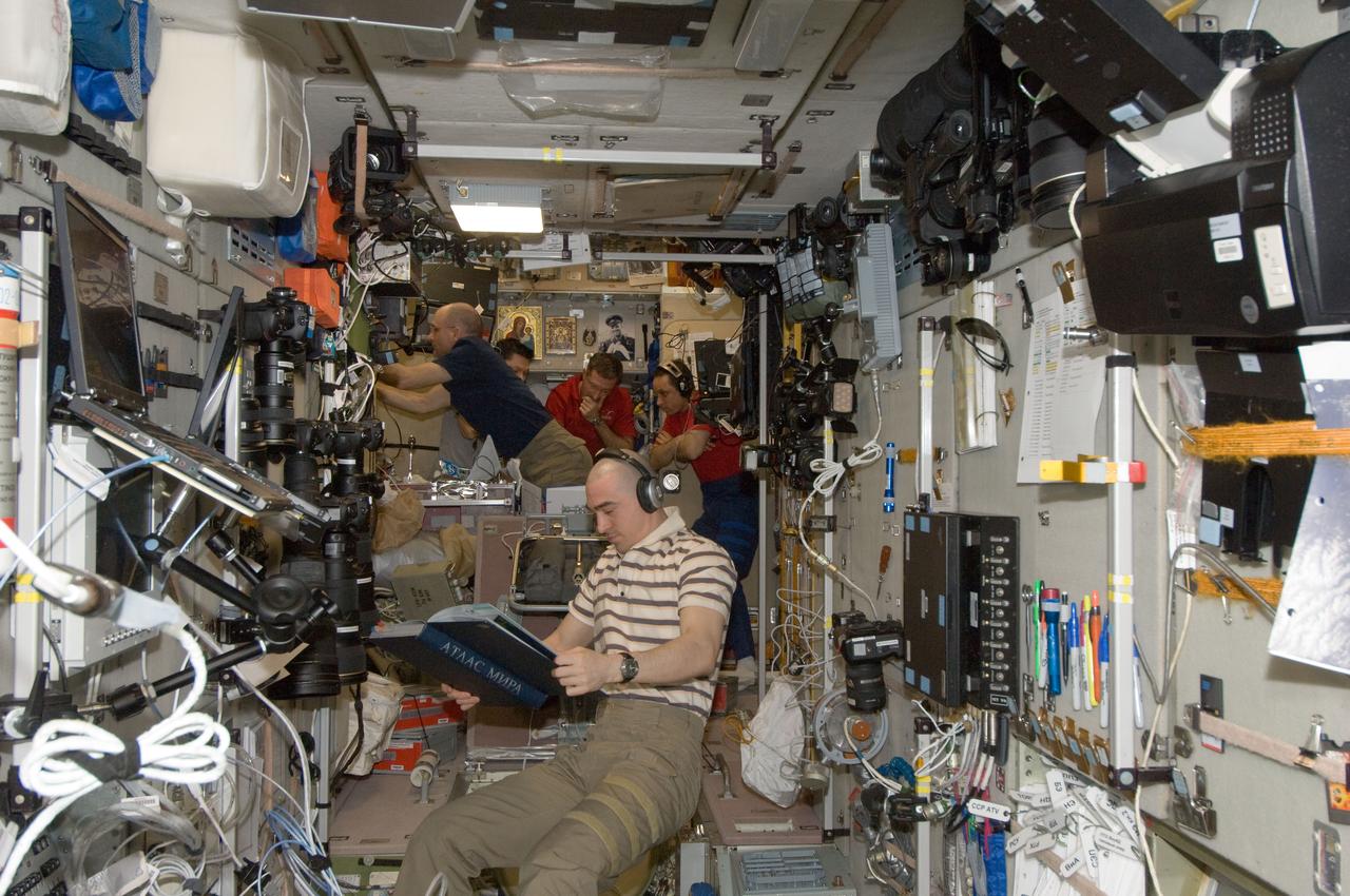 ISS030-E-173969 (24 March 2012) --- Expedition 30 crew members are pictured in the Zvezda Service Module of the International Space Station as they prepare to move to the appropriate Soyuz vehicles, due to the possibility that space debris could pass close to the station. Burbank, Shkaplerov and Ivanishin sheltered in the Soyuz TMA-22 spacecraft attached to the Poisk Mini-Research Module 2 (MRM2) while Kononenko, Kuipers and Pettit took to the Soyuz TMA-03M docked to the Rassvet Mini-Research Module 1 (MRM-1).