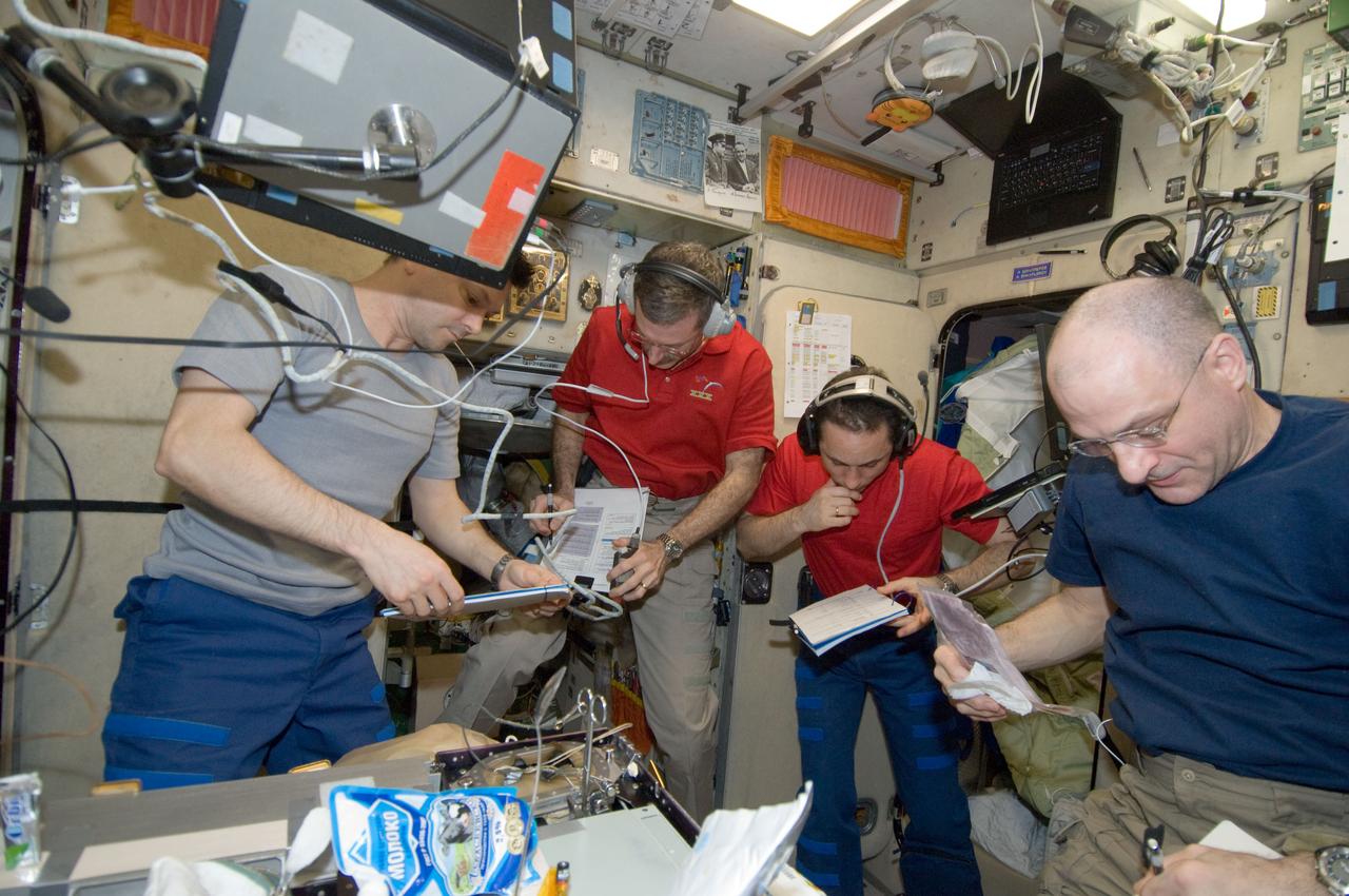 ISS030-E-173973 (24 March 2012) --- NASA astronaut Dan Burbank (second left), Expedition 30 commander; along with Russian cosmonauts Oleg Kononenko (left) and Anton Shkaplerov and NASA astronaut Don Pettit, all flight engineers, are pictured in the Zvezda Service Module of the International Space Station as they prepare to move to the appropriate Soyuz vehicles, due to the possibility that space debris could pass close to the station. Burbank, Shkaplerov and Ivanishin sheltered in the Soyuz TMA-22 spacecraft attached to the Poisk Mini-Research Module 2 (MRM2) while Kononenko, Kuipers and Pettit took to the Soyuz TMA-03M docked to the Rassvet Mini-Research Module 1 (MRM-1).