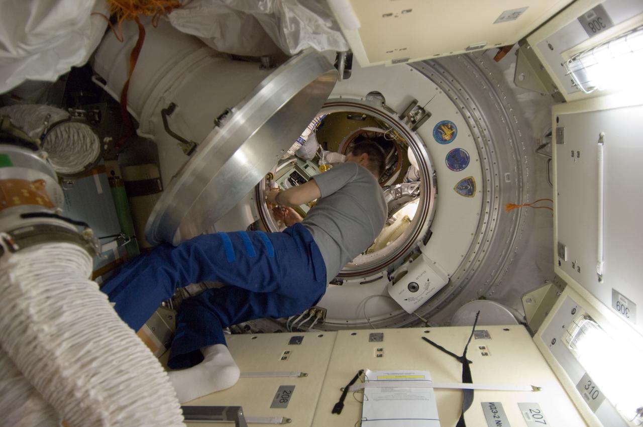 ISS030-E-173977 (24 March 2012) --- Russian cosmonaut Oleg Kononenko, Expedition 30 flight engineer, works in a hatchway on the International Space Station as crew members prepare to move to the appropriate Soyuz vehicles, due to the possibility that space debris could pass close to the station. Burbank, Shkaplerov and Ivanishin sheltered in the Soyuz TMA-22 spacecraft attached to the Poisk Mini-Research Module 2 (MRM2) while Kononenko, Kuipers and Pettit took to the Soyuz TMA-03M docked to the Rassvet Mini-Research Module 1 (MRM-1).