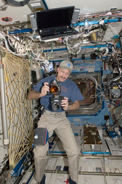 NASA image: Burbank holds cameras in the U.S. Laboratory