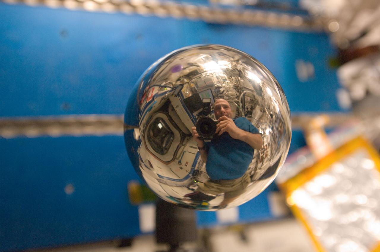 ISS030-E-175968 (19 Feb. 2012) --- A close look at this four-inch polished metal sphere onboard the International Space Station reveals a reflected image of NASA astronaut Don Pettit, Expedition 30 flight engineer. Using a 25-mm lens, Pettit took a series of pictures of the sphere.
