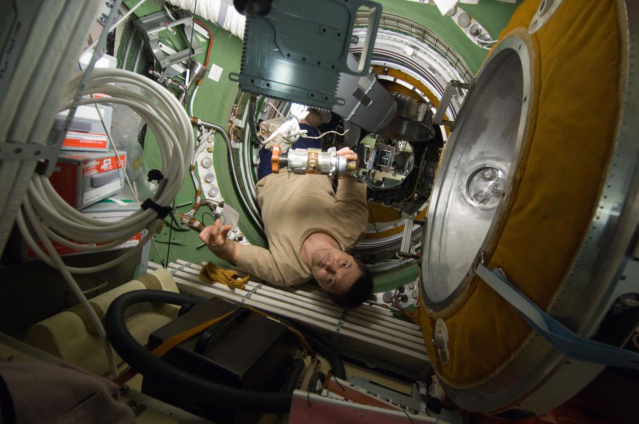 ISS030-E-177117 (12 March 2012) --- Russian cosmonaut Oleg Kononenko, Expedition 30 flight engineer, performs removal and replacement of the KVD Pressure Equalization Valve (PEV) in the transfer compartment between the Zarya Functional Cargo Block (FGB) and the Zvezda Service Module of the International Space Station.