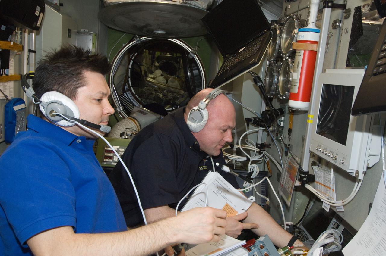 ISS030-E-177317 (28 March 2012) --- European Space Agency astronaut Andre Kuipers and Russian cosmonaut Oleg Kononenko (foreground), both Expedition 30 flight engineers, monitor the approach and docking of ESA’s “Edoardo Amaldi” Automated Transfer Vehicle-3 (ATV-3) in the Zvezda Service Module of the International Space Station.