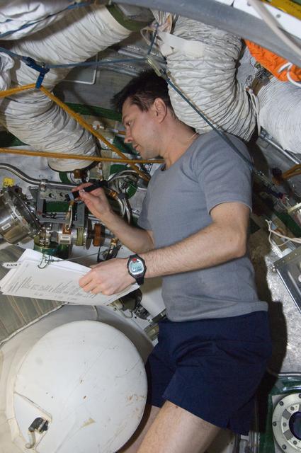 NASA image: Kononenko conducts a leak check in the SM Transfer Tunnel/ATV Vestibule
