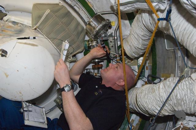 NASA image: Kuipers conducts a leak check in the SM Transfer Tunnel/ATV Vestibule
