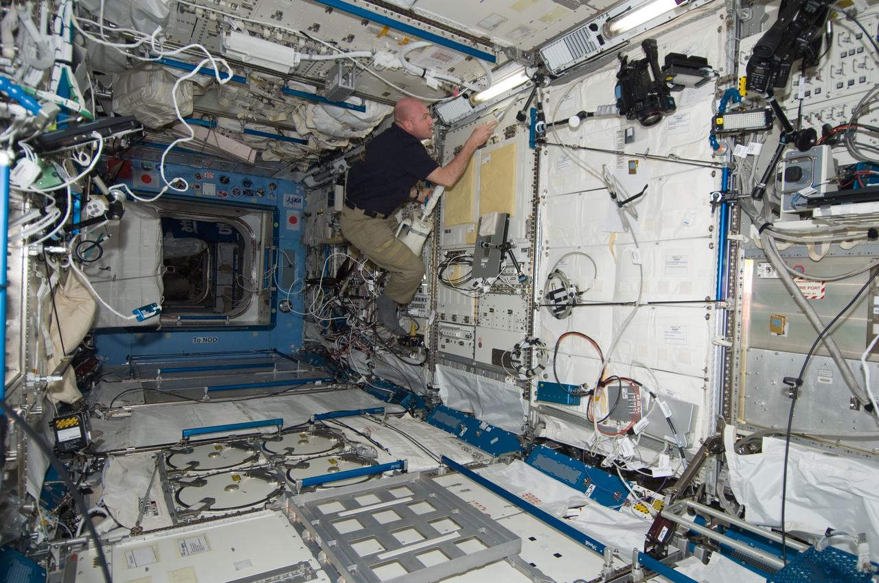 ISS030-E-210319 (15 Jan. 2012) --- European Space Agency astronaut Andre Kuipers, Expedition 30 flight engineer, uses a vacuum cleaner during housekeeping operations in the Kibo laboratory of the International Space Station.