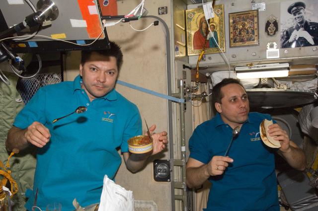NASA image: Kononenko and Shkaplerov enjoy a meal in the SM