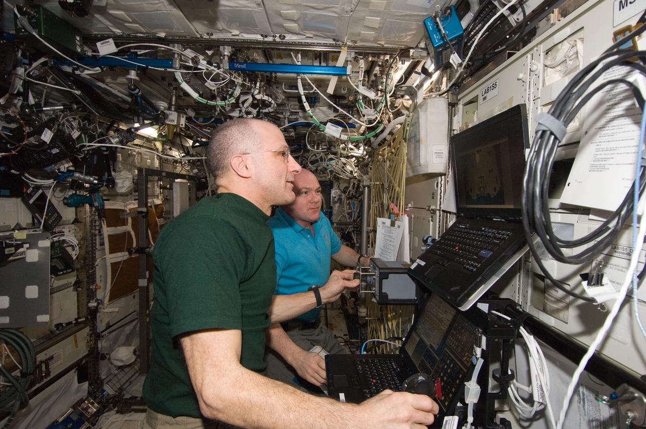 ISS030-E-235593 (11 April 2012) --- In the International Space Station’s Destiny laboratory, NASA astronaut Don Pettit (foreground) and European Space Agency astronaut Andre Kuipers, both Expedition 30 flight engineers, conduct the first of three sessions on the ROBoT simulator in preparation for the arrival of the SpaceX Dragon. Slated for liftoff on April 30, 2012, at 12:22 (EDT) from the Kennedy Space Center, the goal of Dragon’s planned 21-day mission will be to test the unpiloted capsule’s ability to rendezvous with the space station.