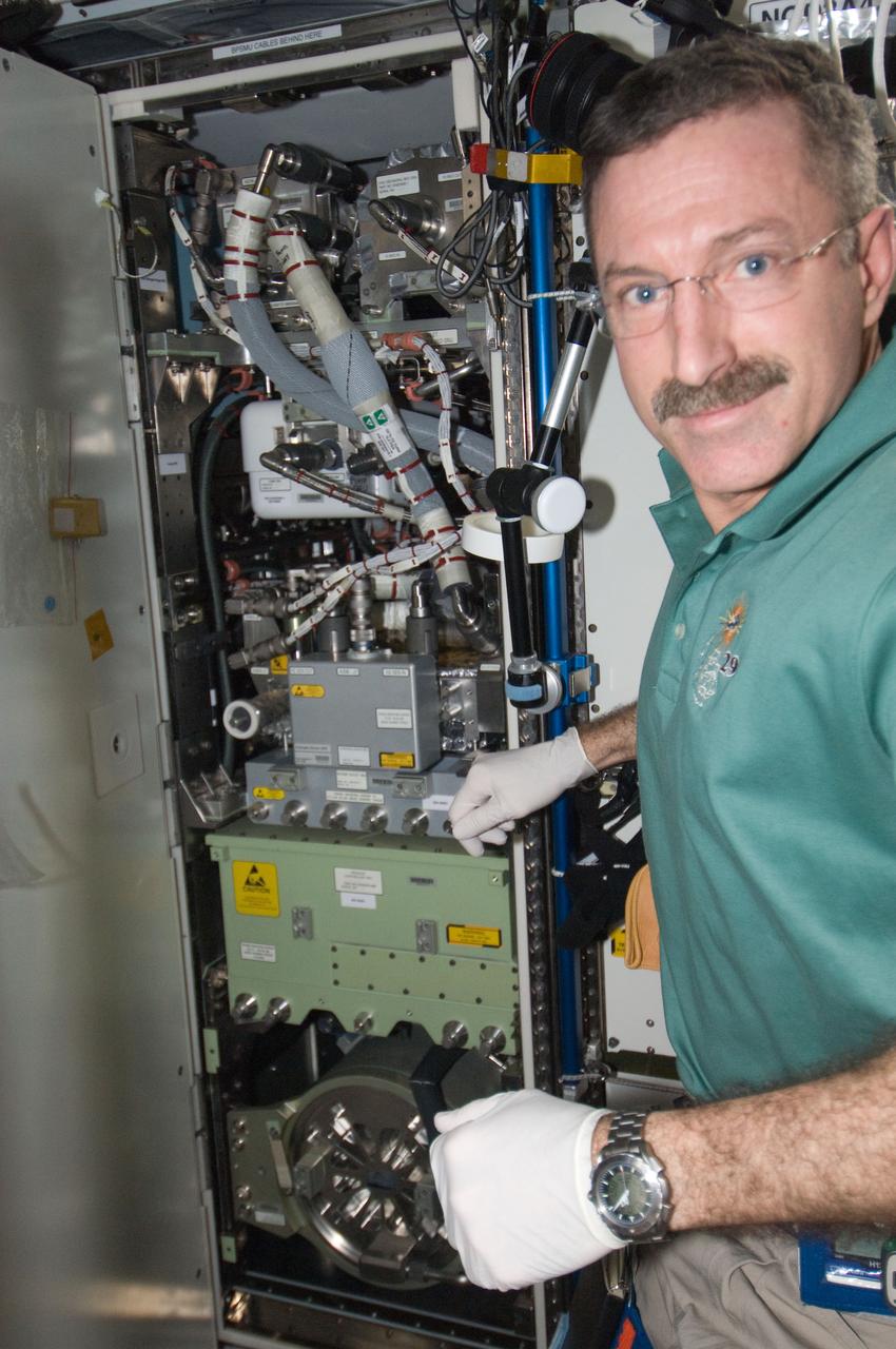 ISS030-E-236919 (18 April 2012) --- NASA astronaut Dan Burbank, Expedition 30 commander, works with the Oxygen Generator System (OGS) rack in the Tranquility node of the International Space Station. Burbank unpowered the OGS, purged the hydrogen sensor Orbital Replacement Unit (ORU) with the Hydrogen Sensor ORU Purge Adapter (HOPA) for return to Earth, and replaced the hydrogen sensor with a new spare, then cleaned the rack Avionics Air Assembly (AAA).