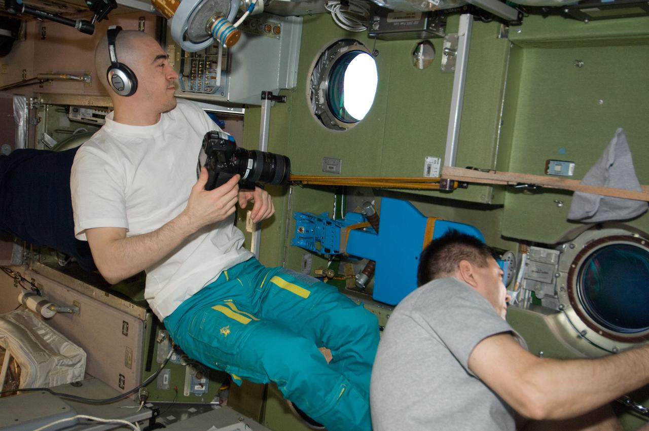 ISS030-E-238163 (19 April 2012) --- From windows in the International Space Station’s Zvezda Service Module, Russian cosmonauts Anatoly Ivanishin (left) and Oleg Kononenko, both Expedition 30 flight engineers, watch the Russian Progress 46 spacecraft after it undocked from the Pirs Docking Compartment.