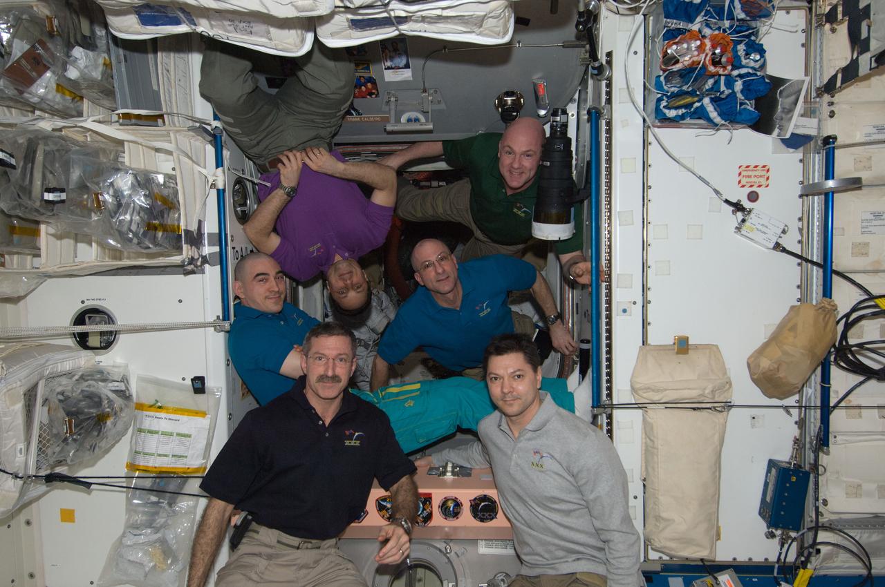 ISS030-E-241374 (21 April 2012) --- Expedition 30 crew members pose for a photo in the Unity node of the International Space Station. Pictured at bottom are NASA astronaut Dan Burbank (left), Expedition 30 commander; and Russian cosmonaut Oleg Kononenko, flight engineer. Pictured from the left (back row) are Russian cosmonauts Anatoly Ivanishin, Anton Shkaplerov, NASA astronaut Don Pettit and European Space Agency astronaut Andre Kuipers, all flight engineers.