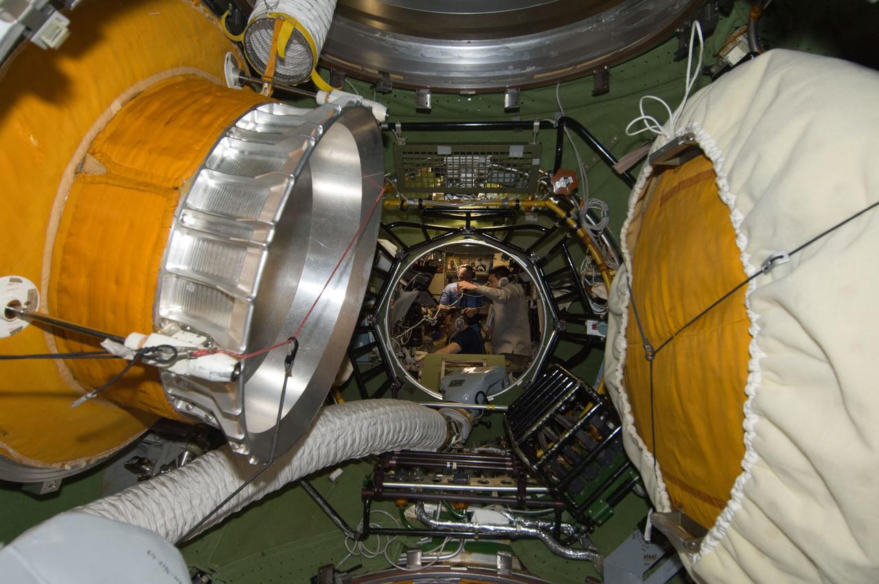 ISS030-E-241385 (22 April 2012) --- Photographed from the transfer compartment between the Zarya Functional Cargo Block (FGB) and the Zvezda Service Module of the International Space Station, Russian cosmonauts Anton Shkaplerov (left), Oleg Kononenko (right) and Anatoly Ivanishin, all Expedition 30 flight engineers, monitor data at the manual TORU docking system controls in Zvezda during approach and docking operations of the unpiloted ISS Progress 47 resupply vehicle. Progress 47 docked automatically to the Pirs Docking Compartment via the Kurs automated rendezvous system at 10:39 a.m. (EDT) on April 22, 2012.