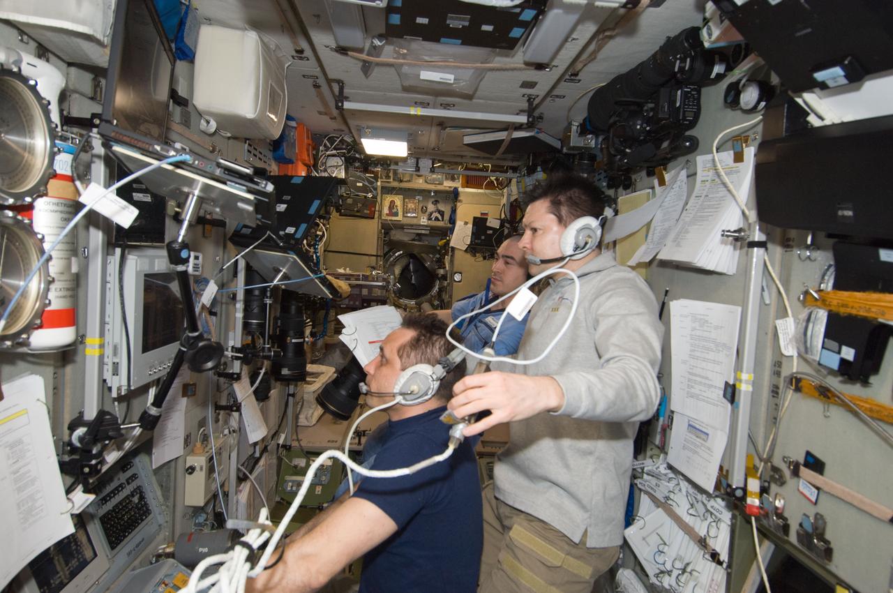 ISS030-E-241387 (22 April 2012) --- Russian cosmonauts Anton Shkaplerov (left), Oleg Kononenko (right) and Anatoly Ivanishin, all Expedition 30 flight engineers, monitor data at the manual TORU docking system controls in the Zvezda Service Module of the International Space Station during approach and docking operations of the unpiloted ISS Progress 47 resupply vehicle. Progress 47 docked automatically to the Pirs Docking Compartment via the Kurs automated rendezvous system at 10:39 a.m. (EDT) on April 22, 2012.