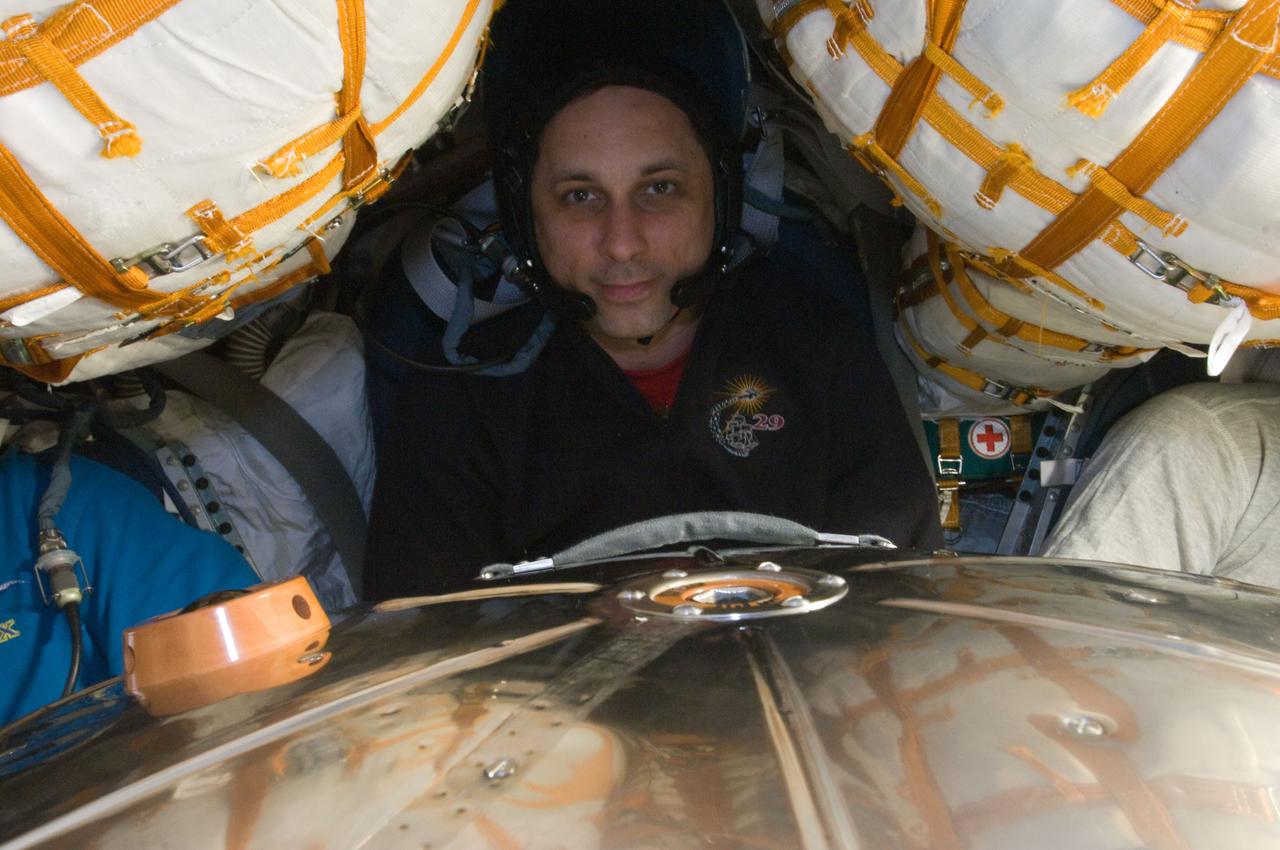 ISS030-E-247150 (23 April 2012) --- Russian cosmonaut Anton Shkaplerov, Expedition 30 flight engineer and Soyuz commander; along with NASA astronaut Dan Burbank (mostly out of frame at left), Expedition 30 commander; and Russian cosmonaut Anatoly Ivanishin (mostly out of frame at right), flight engineer, participate in a standard onboard training exercise in the Soyuz TMA-22 descent module currently docked with the International Space Station. Shkaplerov, Burbank and Ivanishin are scheduled to undock from the station and return to Earth on April 27, 2012.