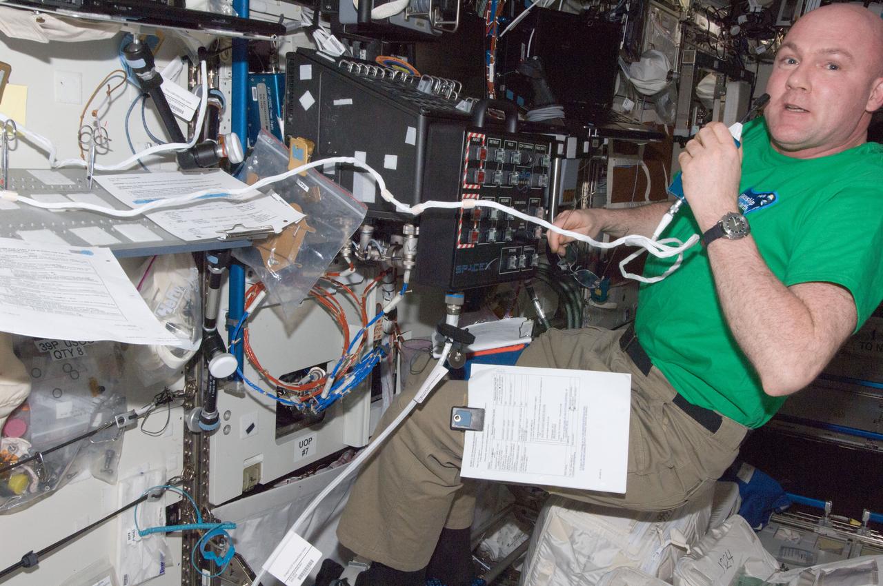 ISS030-E-250643 (24 April 2012) --- European Space Agency astronaut Andre Kuipers, Expedition 30 flight engineer, uses a communication system near a robotic workstation in the Destiny laboratory of the International Space Station.