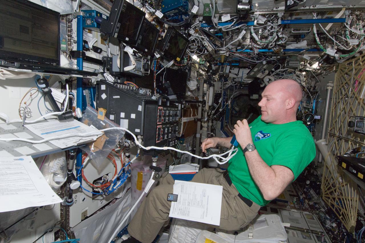 ISS030-E-250651 (24 April 2012) --- European Space Agency astronaut Andre Kuipers, Expedition 30 flight engineer, uses a communication system near a robotic workstation in the Destiny laboratory of the International Space Station.