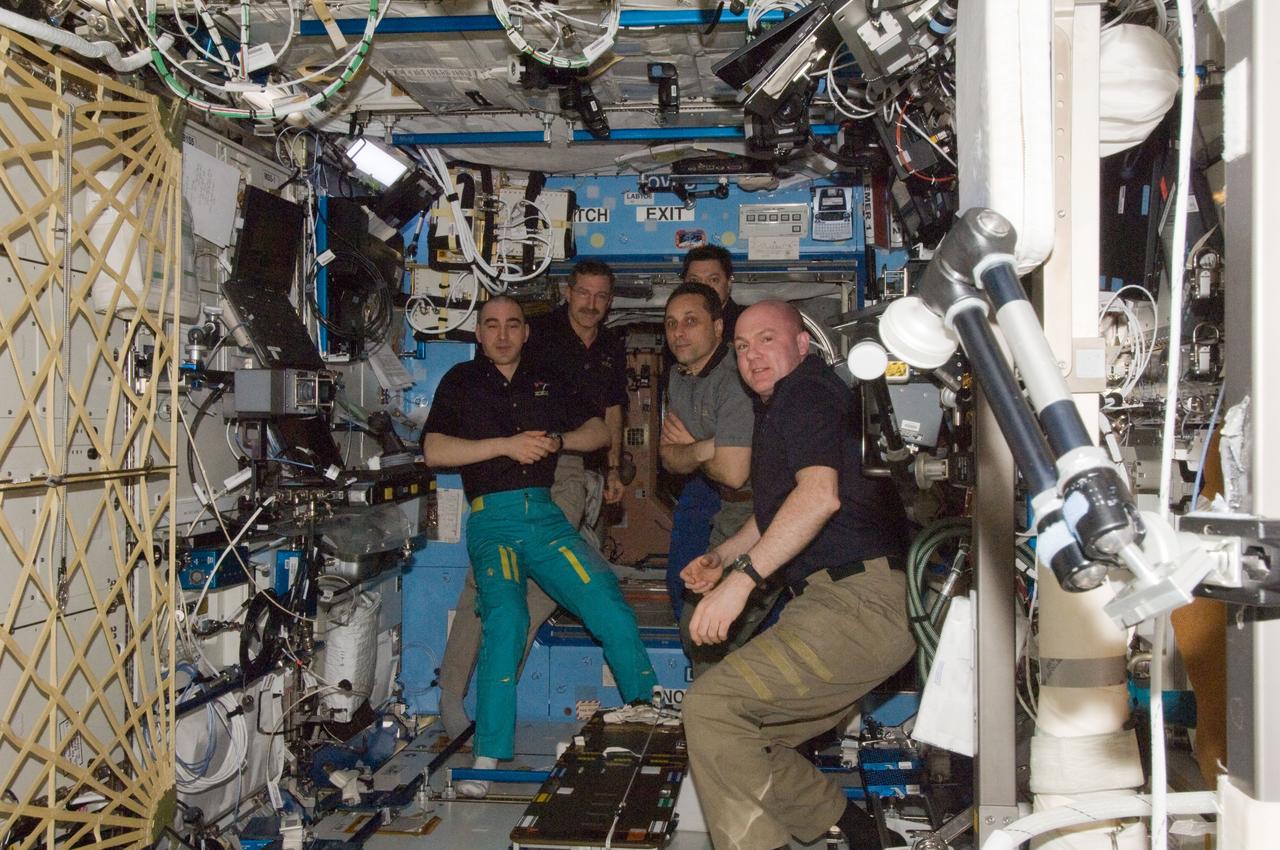 ISS030-E-257799 (27 April 2012) --- Expedition 30 crew members bid farewell to Expedition 31 crew members in the Destiny laboratory of the International Space Station prior to boarding their Soyuz spacecraft for their trip back to Earth. Pictured (from the left) are Russian cosmonaut Anatoly Ivanishin, Expedition 30 flight engineer; NASA astronaut Dan Burbank, Expedition 30 commander; Russian cosmonaut Oleg Kononenko, Expedition 31 commander; Russian cosmonaut Anton Shkaplerov, Expedition 30 flight engineer and Soyuz commander; and European Space Agency astronaut Andre Kuipers, Expedition 31 flight engineer. NASA astronaut Don Pettit, Expedition 31 flight engineer, is out of frame.