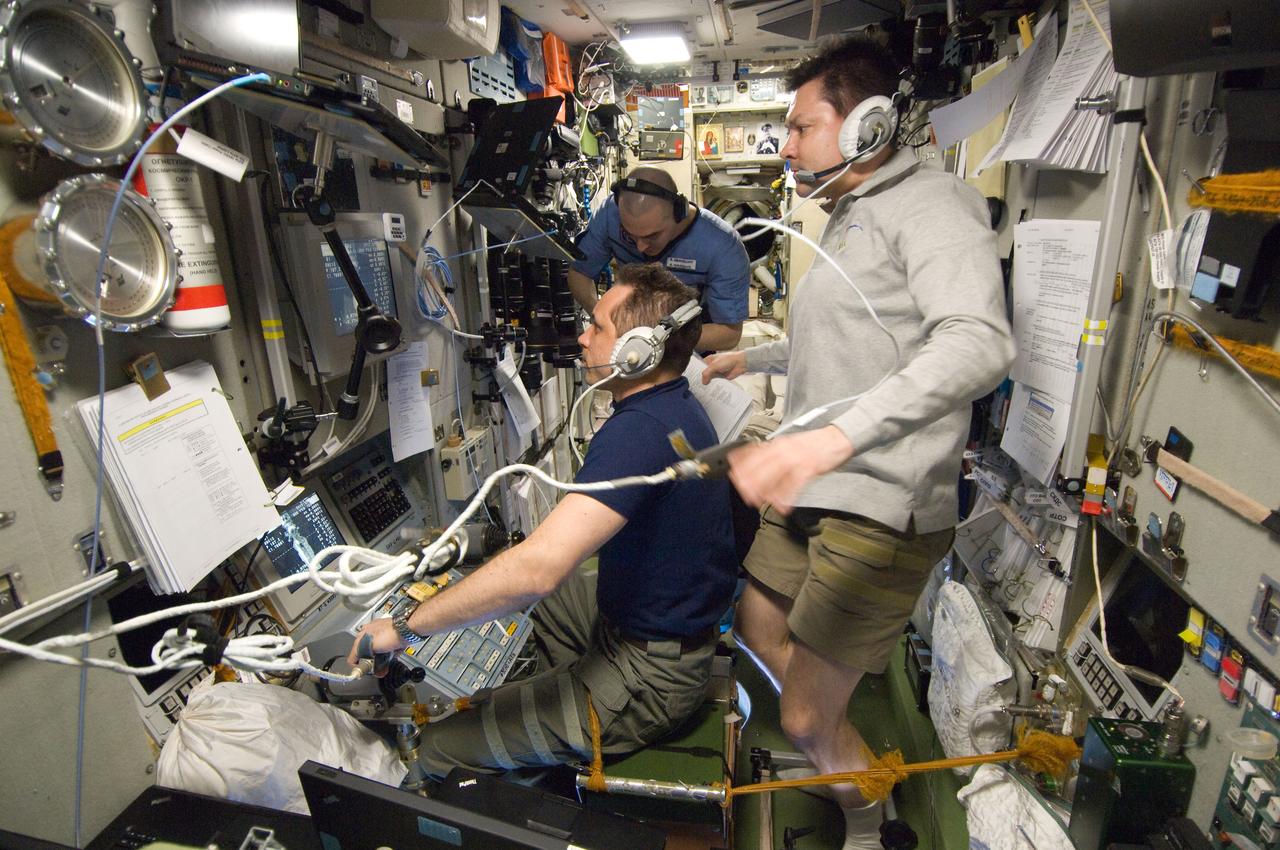 ISS030-E-267689 (22 April 2012) --- Russian cosmonauts Anton Shkaplerov (left), Oleg Kononenko (right) and Anatoly Ivanishin, all Expedition 30 flight engineers, monitor data at the manual TORU docking system controls in the Zvezda Service Module of the International Space Station during approach and docking operations of the unpiloted ISS Progress 47 resupply vehicle. Progress 47 docked automatically to the Pirs Docking Compartment via the Kurs automated rendezvous system at 10:39 a.m. (EDT) on April 22, 2012.