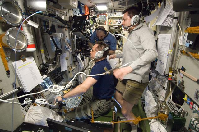 NASA image: Expedition 30 Crewmembers Monitor Data in the SM during Approach