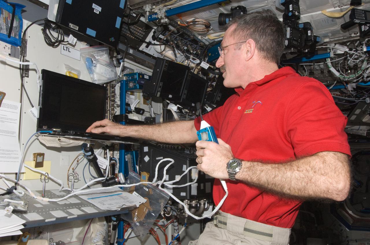 ISS030-E-267797 (25 April 2012) --- NASA astronaut Dan Burbank, Expedition 30 commander, holds a microphone while using a computer in the Destiny laboratory of the International Space Station.
