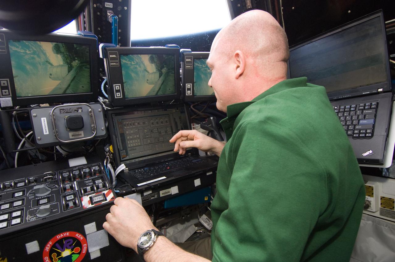ISS030-E-272092 (17 April 2012) --- European Space Agency astronaut Andre Kuipers, Expedition 30 flight engineer, works the controls of the Canadarm2 Space Station Remote Manipulator System (SSRMS) in the Cupola of the International Space Station.
